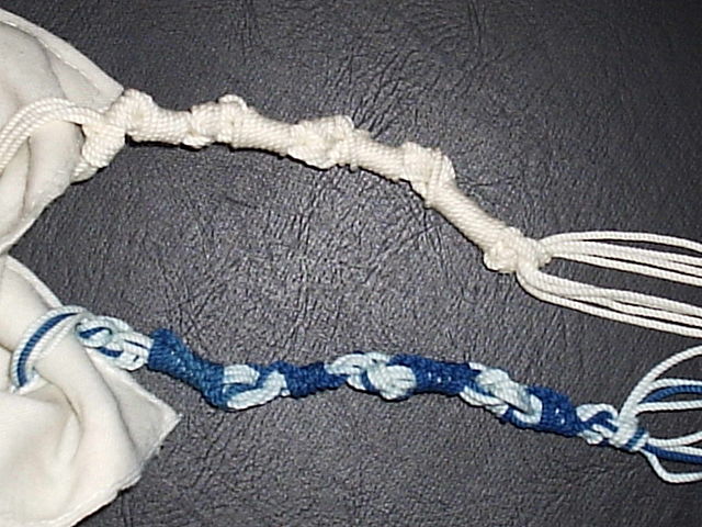 Ashkenazi (white) and Sephardic (blue and white) styles of tzitzit windings and knots. See  https://commons.wikimedia.org/wiki/File:Tzitzith.jpg for source information.